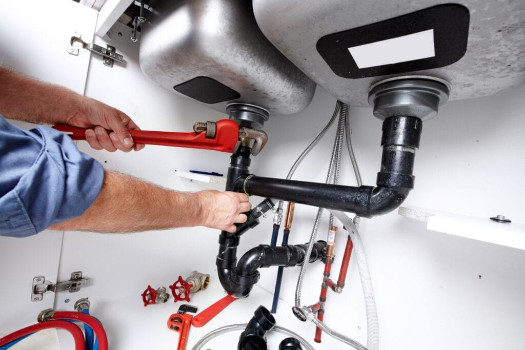 Dunedin Plumbing Pros fixing under sink plumbing and drain pipes