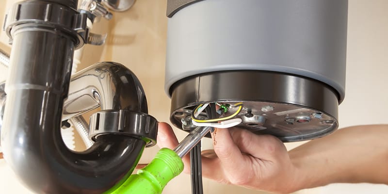 Dunedin, Florida plumber servicing water heater pipe connection