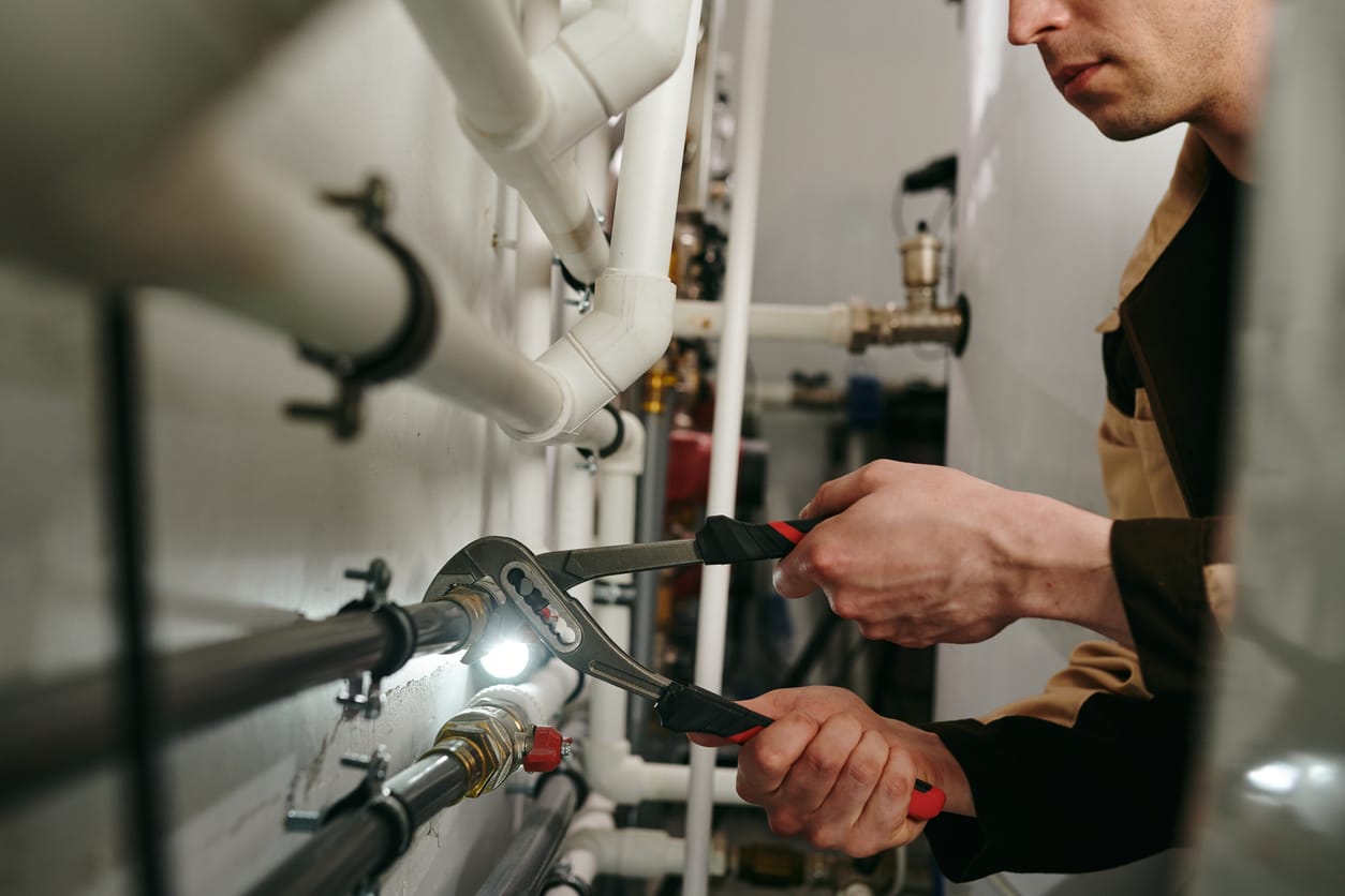 Plumbers maintaining commercial plumbing pipes in Dunedin